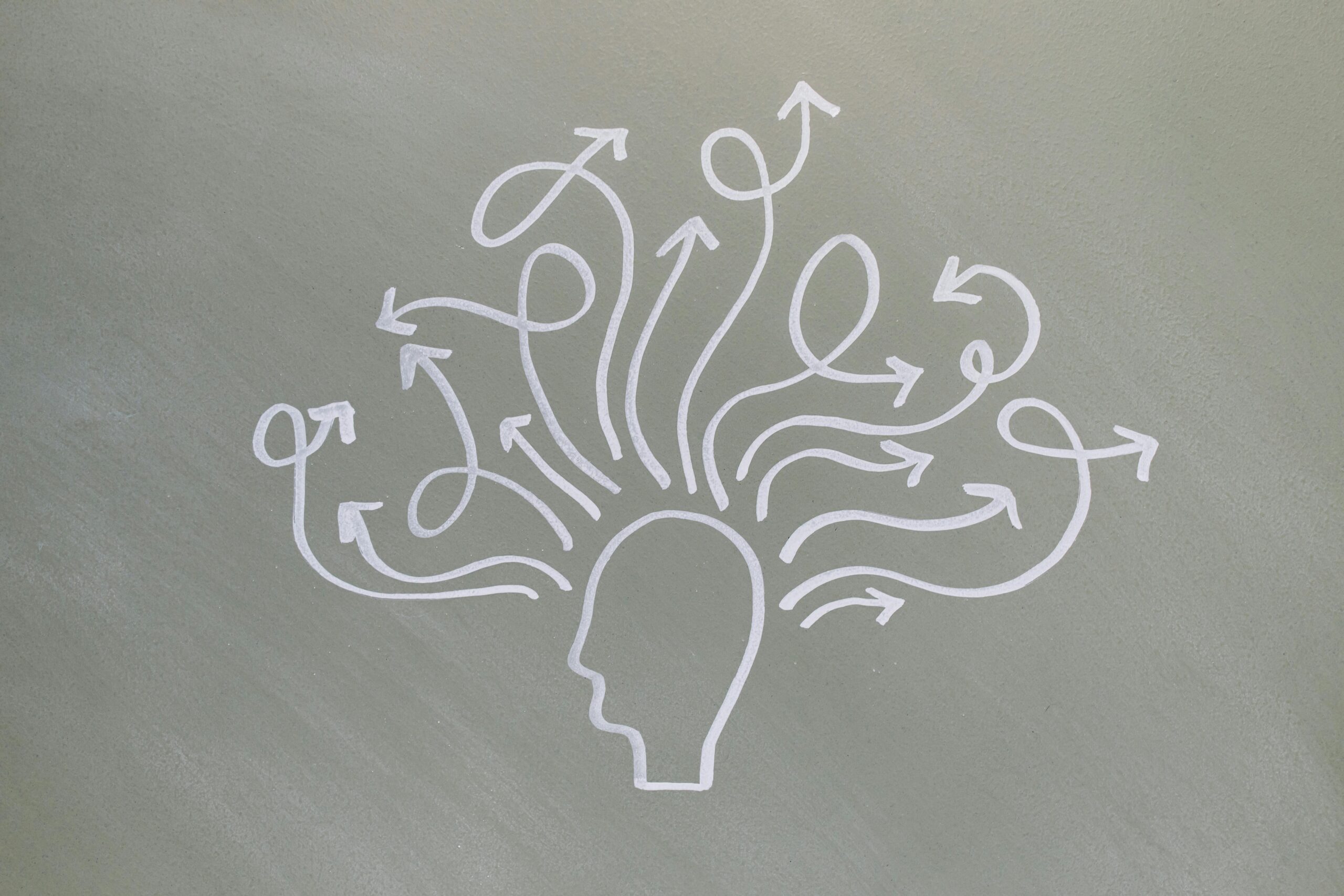 Conceptual chalk drawing illustrating mental health challenges with arrows representing thoughts.